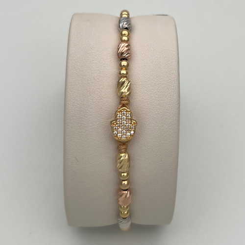 PULSERA TEJIDA CON DIJE MANO DE FÁTIMA, BALINES Y CANITILLOS DIAMANTADOS EN TRES OROS DE 18K